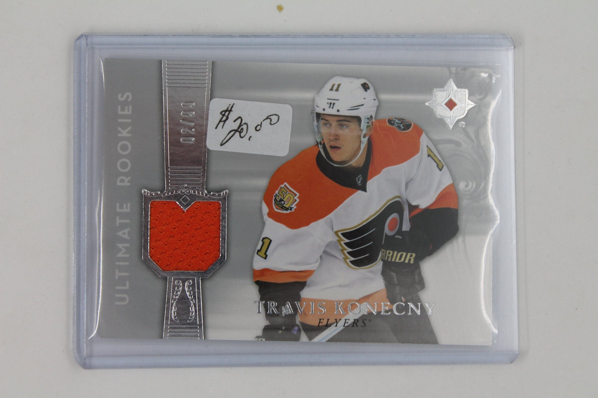 Travis Konecny 2016-17 Ultimate Collection - Ultimate Rookies Jersey Card #2/99